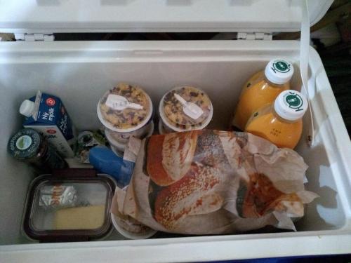 an open refrigerator filled with food and drinks at Iceland yurt in Akureyri