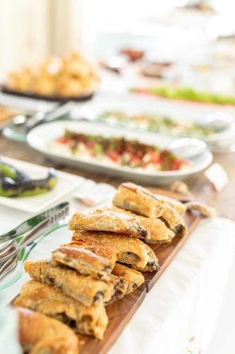 a table topped with plates of food on a table at Deniz Kabugu Hotel in Alacati