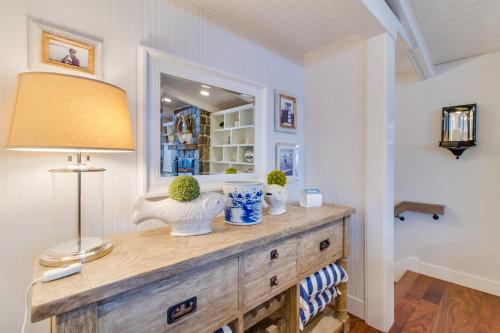 a room with a dresser with a lamp and a mirror at South Hampton House in Tolovana Park
