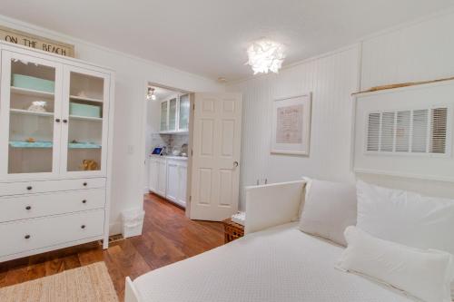 a white bedroom with a bed and a closet at South Hampton House in Tolovana Park