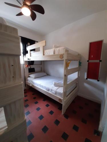 two bunk beds in a room with a ceiling fan at Noah boutique hostels Medellín in Medellín