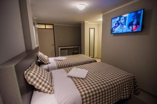 Ένα ή περισσότερα κρεβάτια σε δωμάτιο στο Hostal Montalvo