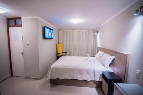 Ένα ή περισσότερα κρεβάτια σε δωμάτιο στο Hostal Montalvo