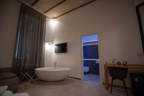 a large bathroom with a tub and a window at La Lupa in Matera