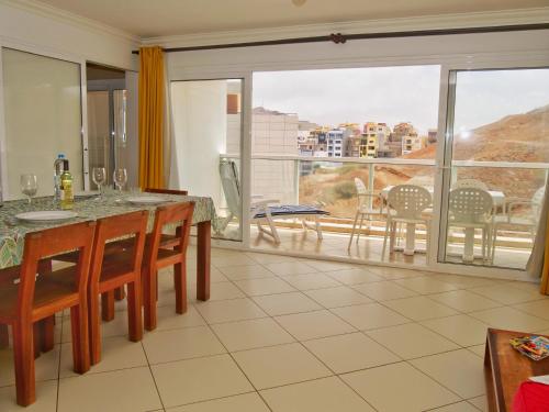 a dining room with a table and a view of the city at Suite Mariposa Sospesa Sul Mare in Mindelo
