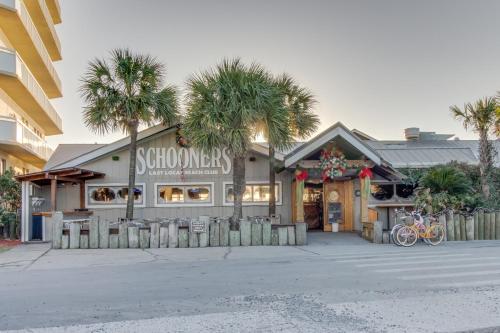 a store with palm trees in front of a building at The Top of the Gulf #612 in Panama City Beach
