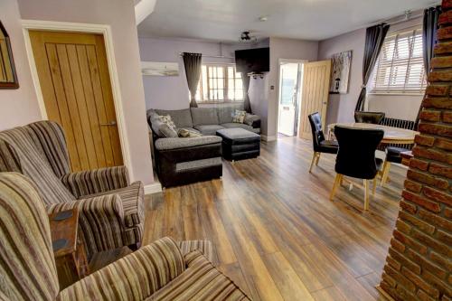 a living room with a couch and chairs and a table at The Old Joiner's Shop in Whitby