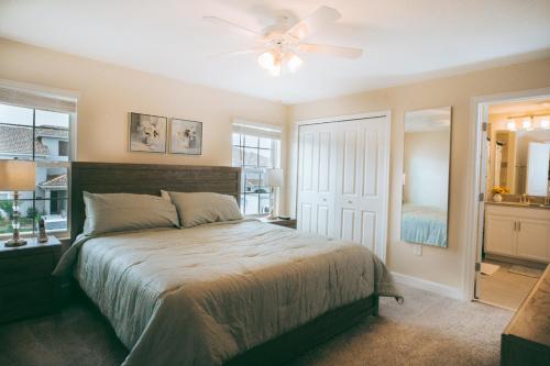 a bedroom with a bed and a ceiling fan at Luxury Thownhouse with private pool in Kissimmee