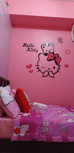 a bedroom with a hello kitty sticker on the wall at Hello Kitty at Wind Residences Tagaytay in Tagaytay