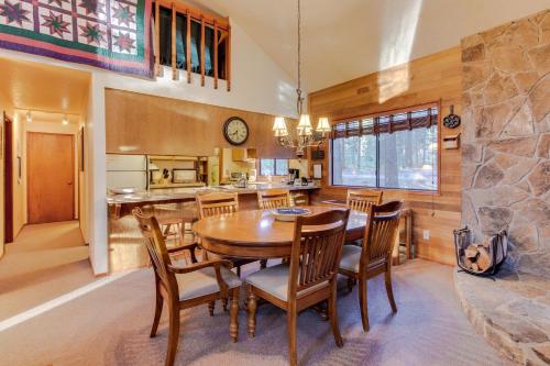 a kitchen and dining room with a wooden table and chairs at Otter Lane 12 | Discover Sunriver in Sunriver