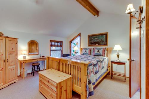 a bedroom with a wooden bed and a desk and a desk at Otter Lane 12 | Discover Sunriver in Sunriver