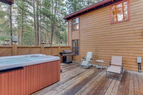 a hot tub on a deck next to a house at Otter Lane 12 | Discover Sunriver in Sunriver