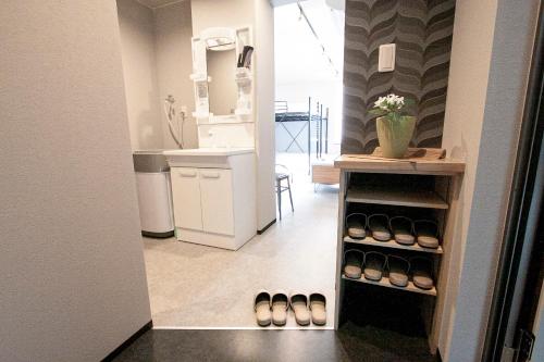 a hallway with a room with shoes on a shelf at UCHI Living Stay TOYOHIRA in Sapporo