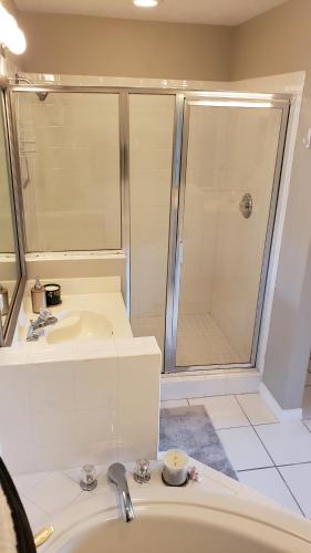 a bathroom with a shower and a sink at Vacation in Paradise in Lely Resort