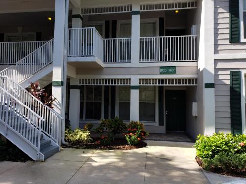 a apartment building with stairs and a walkway at Vacation in Paradise in Lely Resort