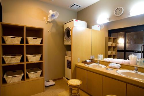 a bathroom with a sink and a mirror at Hotel Route-Inn Nanao Ekihigashi in Nanao