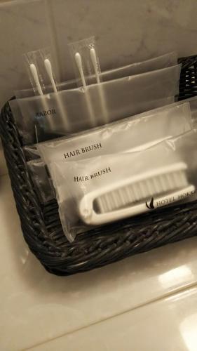 a basket filled with toothbrushes and toothpaste at Hotel Hokke Club Kagoshima in Kagoshima