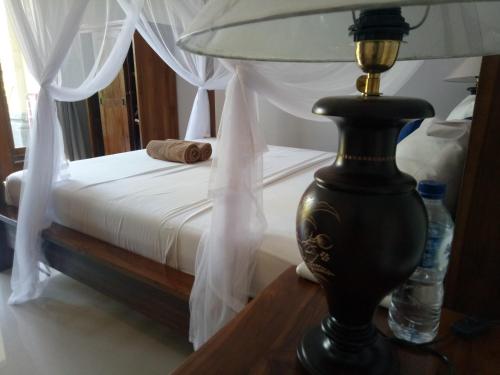 A bed or beds in a room at Suryadina Guest House