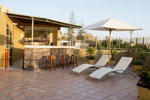 a patio with chairs and an umbrella and a bar at El Cabildo Hotel in Arequipa