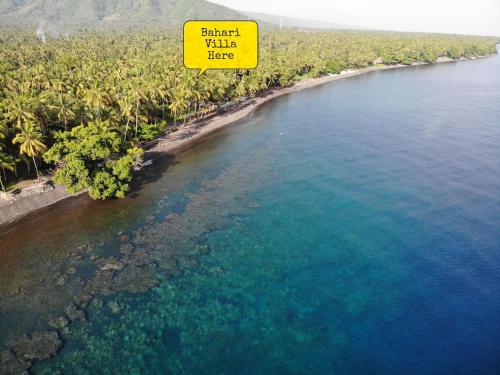 an island with a sign that reads planet villa here at Bahari Villa Tejakula in Tejakula