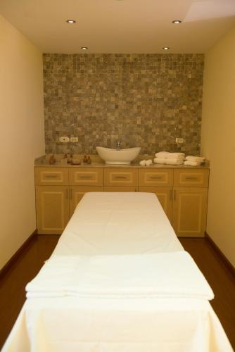 a bathroom with a sink and a white table at El Cabildo Hotel in Arequipa