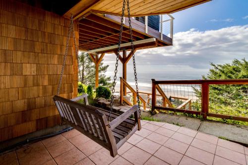 a porch swing with a view of the ocean at Berni's Ocean View Castle - an Oceanside Legend in Oceanside