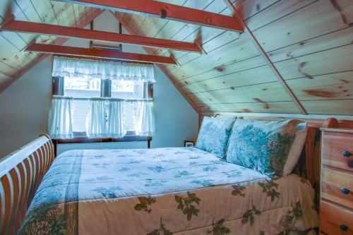 a bedroom in a tiny house with a bed and a window at Cozy Bobby Grey Manor in South Lake Tahoe