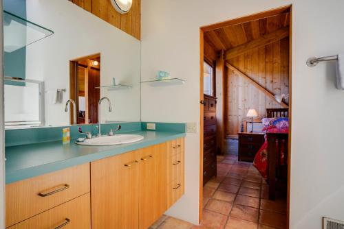 a bathroom with a sink and a mirror at Compass Rose in Sea Ranch