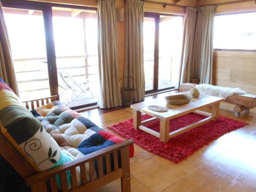 a living room with a couch and a coffee table at Hotel Parque Quilquico in Castro