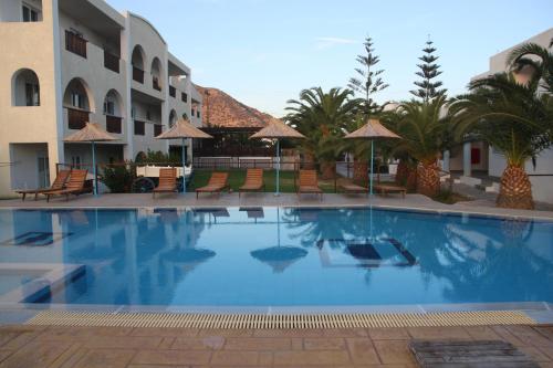 a large swimming pool in front of a hotel at Kalimera Mare in Kardamaina