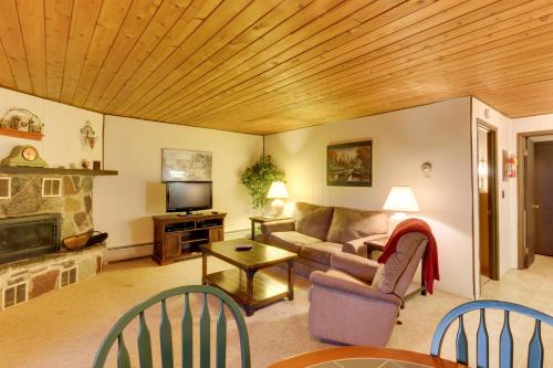 a living room with a couch and a fireplace at Bay Point Hillside 17A Down in Whitefish