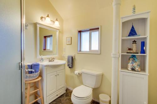 Un baño con inodoro, lavabo y espejo. en Nye Beach Retreat, en Newport