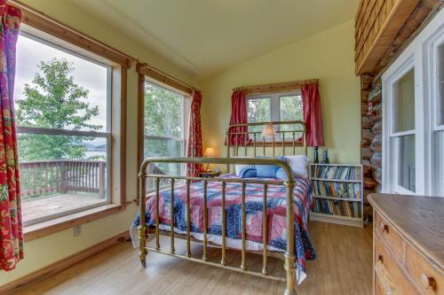 - une chambre avec un lit dans une pièce dotée de fenêtres dans l'établissement Mackinaw Getaway, à Sagle