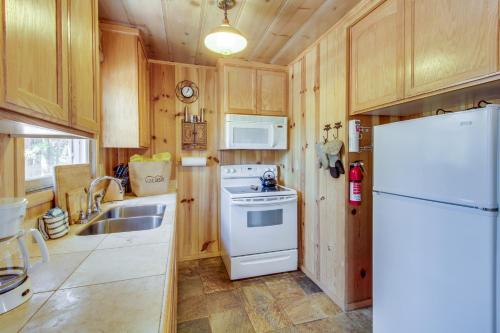 a kitchen with a white refrigerator and a sink at Cozy Bobby Grey Manor in South Lake Tahoe