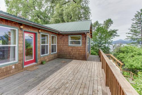 a home with a wooden deck and a house at Mackinaw Getaway in Sagle