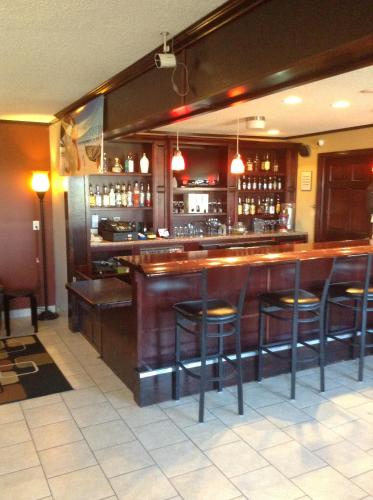 a bar in a restaurant with bar stools at Baymont by Wyndham Dubuque in Dubuque