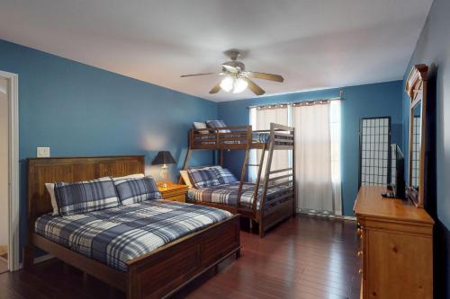 a bedroom with two bunk beds and a ceiling fan at 125B E. Lantana in South Padre Island