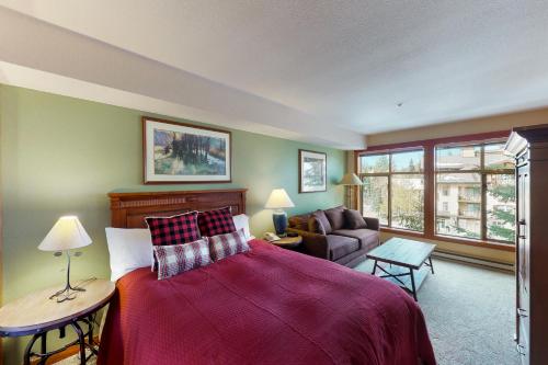 a bedroom with a large bed and a couch at Powderhorn Lodge 311: Poppy Suite in Solitude