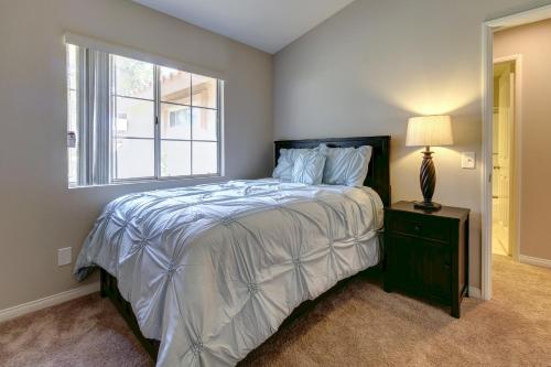 a bedroom with a large bed and a window at Buttercup Delight Permit# 106,312 in Bermuda Dunes
