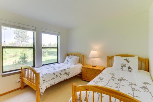 a bedroom with two beds and a window at Fairway Village 28 | Discover Sunriver in Sunriver