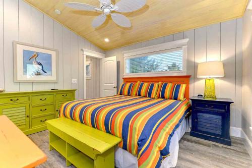 a bedroom with a bed and a ceiling fan at Wine Down in Ilexhurst