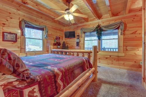 a bedroom with a bed in a log cabin at Bearfoot Retreat in Waldens Creek