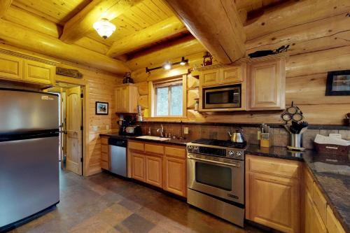 a large kitchen with wooden walls and wooden cabinets at Loggers Landing in Lakeshore