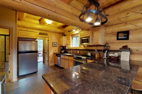 a large kitchen with a large counter top in a cabin at Loggers Landing in Lakeshore