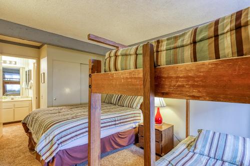 a bedroom with two bunk beds and a bathroom at Mammoth Ski & Racquet 124 in Mammoth Lakes