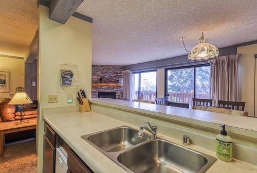 a kitchen with a sink and a large window at Mammoth Ski & Racquet 124 in Mammoth Lakes