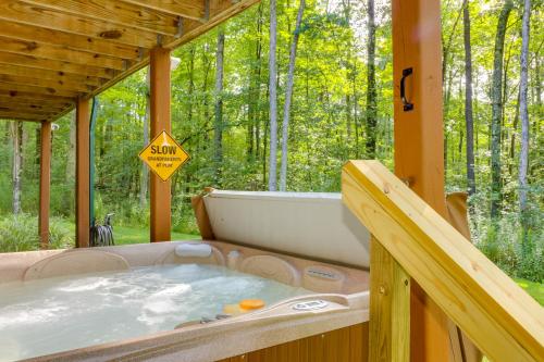 a hot tub in a wooden house with a sign at 5 Little Acorns in McHenry