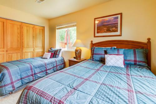a bedroom with two beds and a window at Cottonwoods 455 in Moab