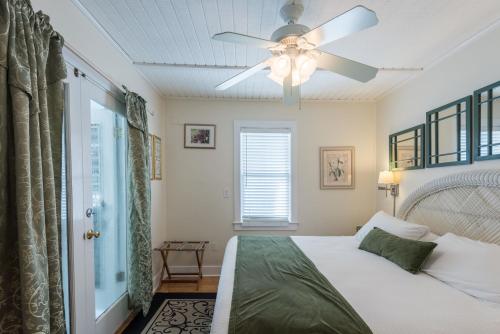 1 dormitorio con 1 cama y ventilador de techo en Amelia House en Key West