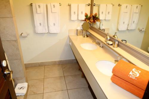 a bathroom with two sinks and a mirror at Sapphire del Mar B-106 Ocean Front Beach Level in Nazareth